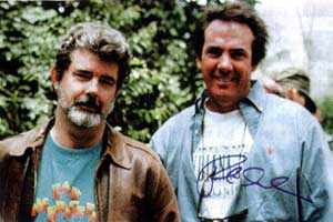 George Lucas in
                his Zak T-shirt (with producer Rick McCallum)